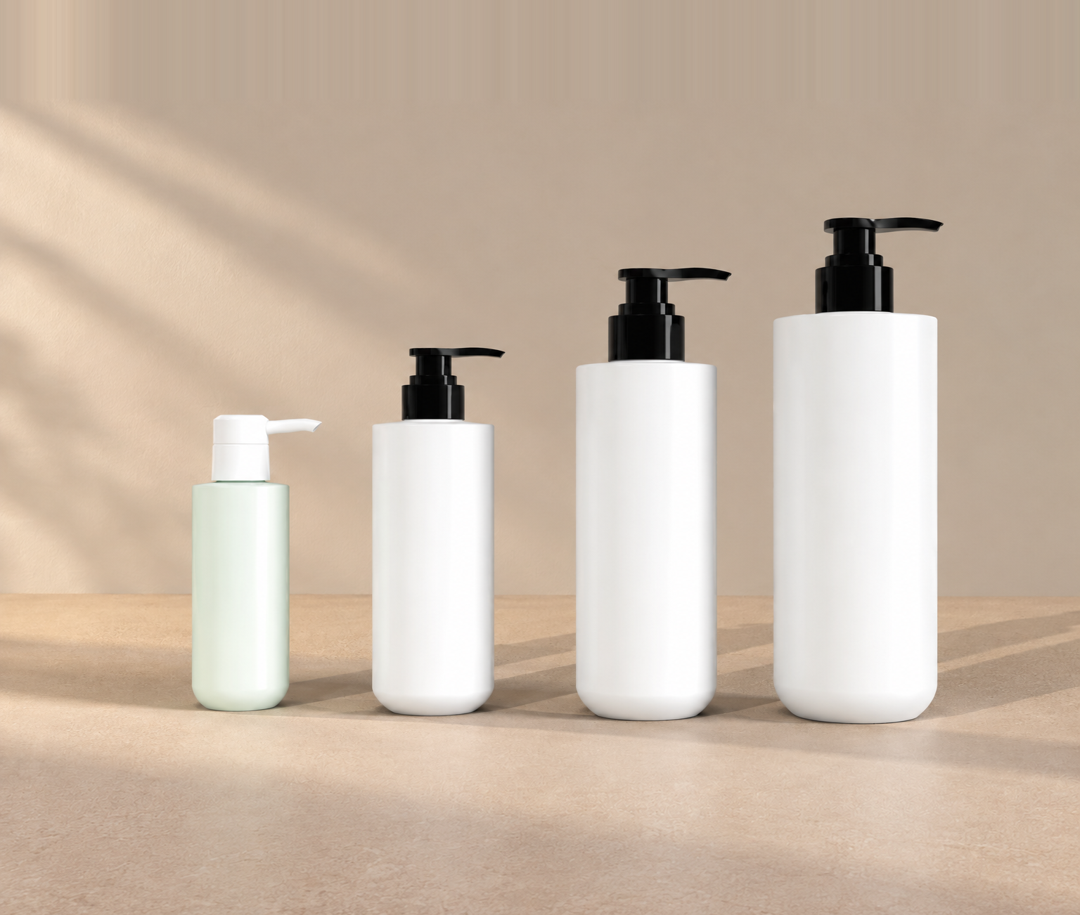 Four round bottom pump bottles in graduated sizes