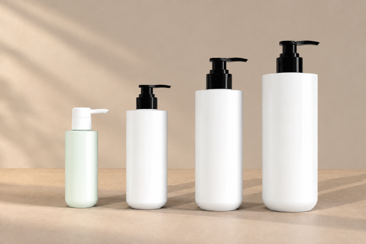 Four round bottom pump bottles in graduated sizes