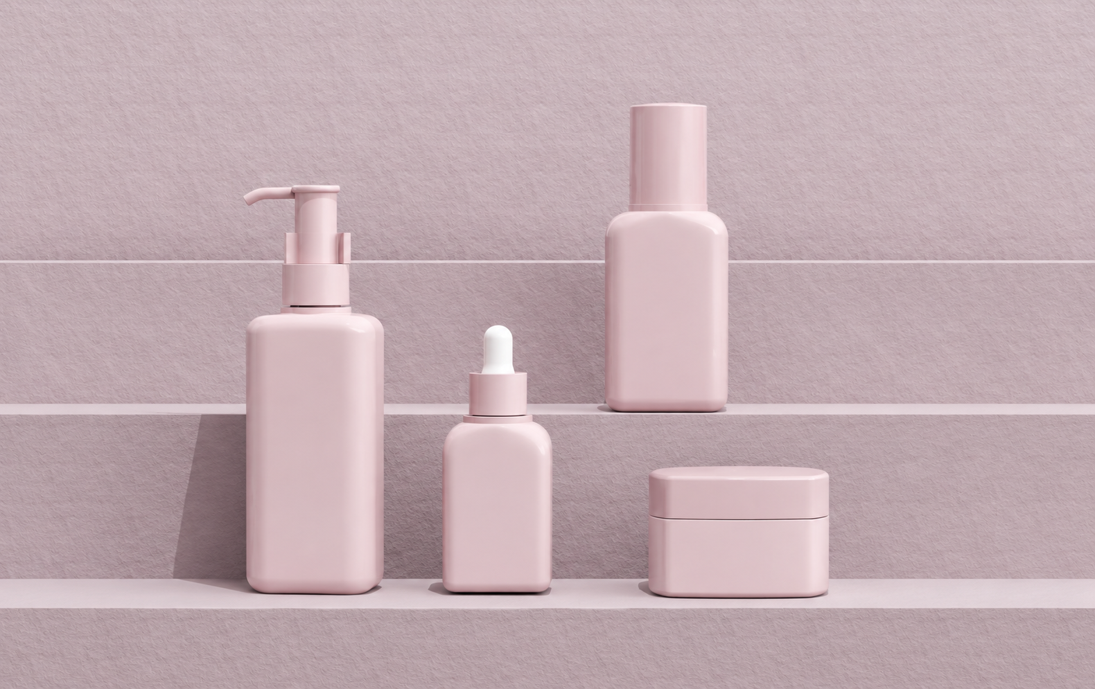 Powder pink round and flat skincare bottles and jar